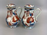 pair of chinese vases with floral designs on them on a white surface
