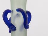 a glass vase with two blue handles on it