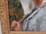 a painting of a woman holding a umbrella in a gold frame
