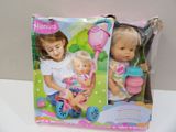 two dolls that are in a box on the table