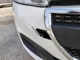a close up of a car ' s front bumper and grille