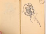 someone is drawing a bird on a book with a pencil