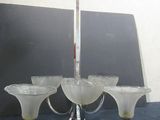 a chandelier with five glass shades hanging from it