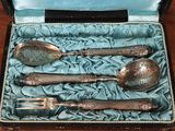 silverware in a box on a wooden table with a blue cloth