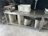 a kitchen with a bunch of trash cans on the counter