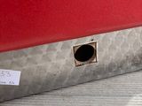 a small hole in the side of a red car