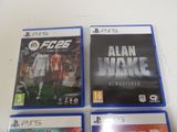 three video games are sitting on a white surface
