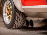 a close up of a red car with a big tire