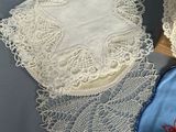 three white doily on a table with a blue cloth