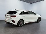 the rear end of a white car in a white room