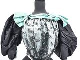 an image of a mannequin with a black and white top and green bow tie