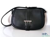 a black purse that is sitting on a table