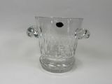 a clear glass vase with a black dot in it