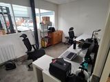 an image of an office with a lot of work on the desks