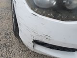 a close up of a car ' s headlight and front bumper