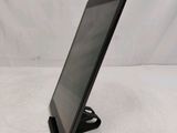 a close up of a tablet computer on a stand on a white surface