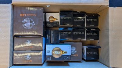 a cardboard box filled with many different types of electronic devices