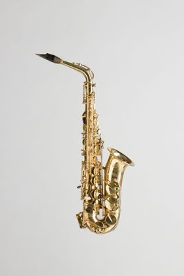 a close up of a gold saxophone on a white background