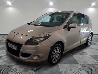 a picture of a beige car parked on a checkered floor