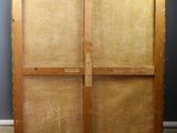 an old wooden easel with a cross on the top of it
