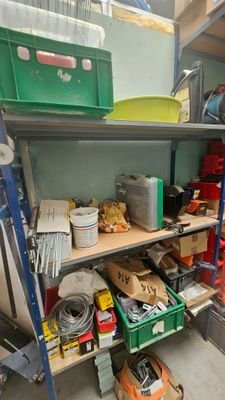 a shelf full of assorted items in a garage