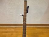 a close up of a guitar on a stand on a wooden floor