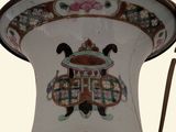 a large vase with a red flower on it