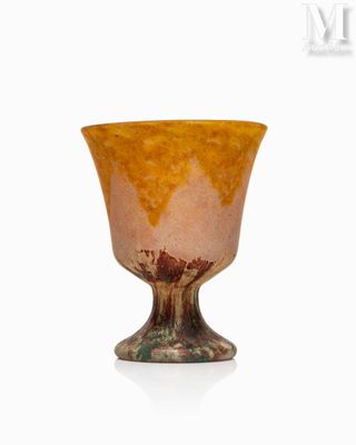 a glass cup that is sitting on a white surface