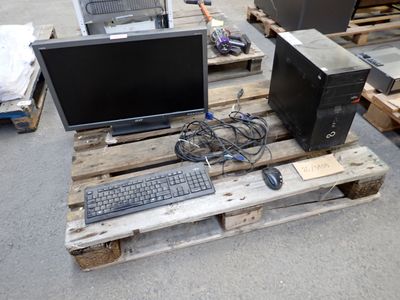 a computer sitting on a pallet with a keyboard and mouse
