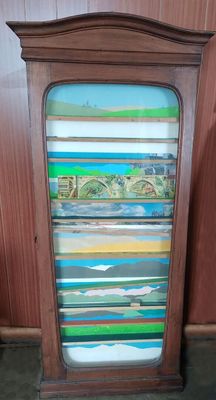an old wooden bookcase with many books on top of it
