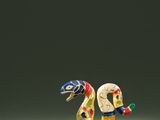 a close up of a figurine of a bird on a table