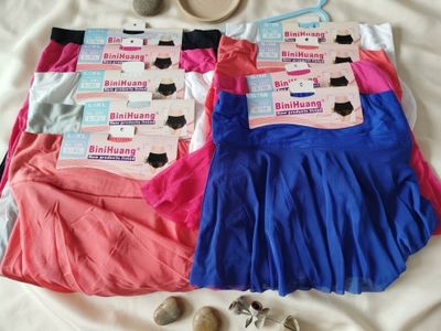 three pairs of underwear are laid out on a bed next to a teddy bear