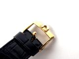 a close up of a watch on a white surface