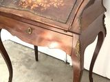 a small wooden desk with a drawer on top of it