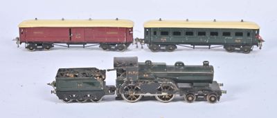 three toy trains sitting side by side on a white surface