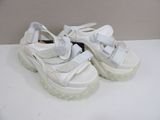 white platform shoes with white soles on a white surface