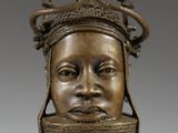 a bronze statue of a man with a crown on his head