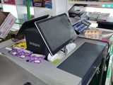 a cash register in a store with a lot of items