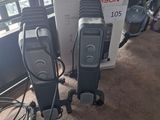 two electric heaters sitting next to each other on the floor