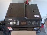 a printer sitting on top of a stack of boxes