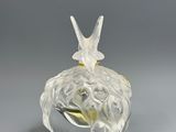an image of a glass figurine with a bird on it ' s head
