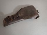 a brown leather case with a metal handle on a white surface