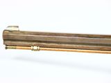 an old brass pipe with a wooden handle on a white background