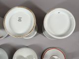 several different types of cups and saucers are arranged on a table