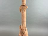 sculpture of a giraffe standing on a black base on a gray background