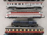 several model trains are stacked on top of each other on a table