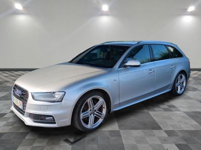 a silver audi wagon parked in a large room with a checkered floor