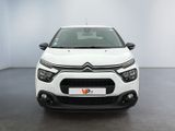 the front of a white citrole parked in a white room