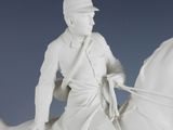 a statue of a man riding a horse with a hat on