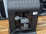 a coffee machine sitting on a table in a kitchen